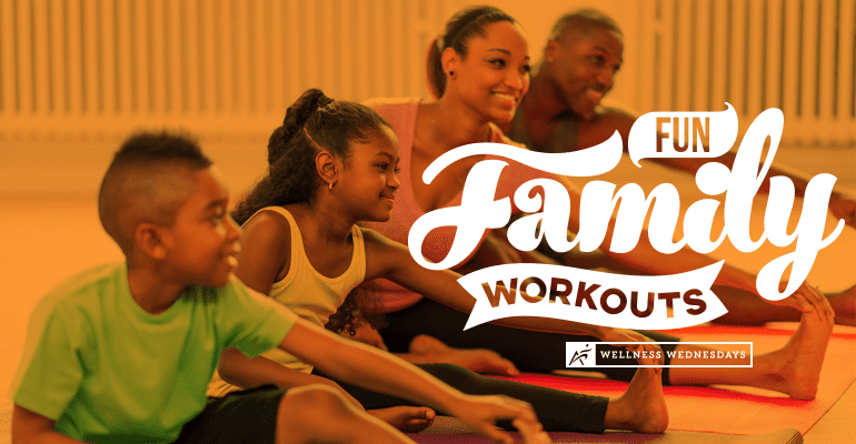 family of four to adults one male one female and two children one boy one girl stretching in room.