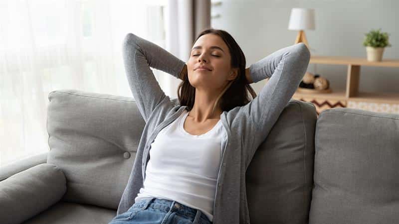 Woman relaxing on couch after receiving physical therapy treatment