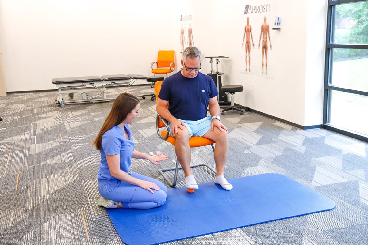 Airrosti Provider walking patient through exercises for plantar fasciitis