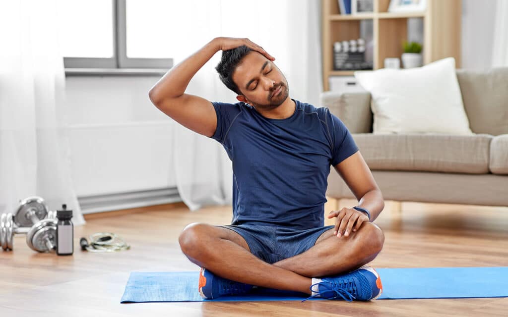 Man Sitting and Stretching His Neck