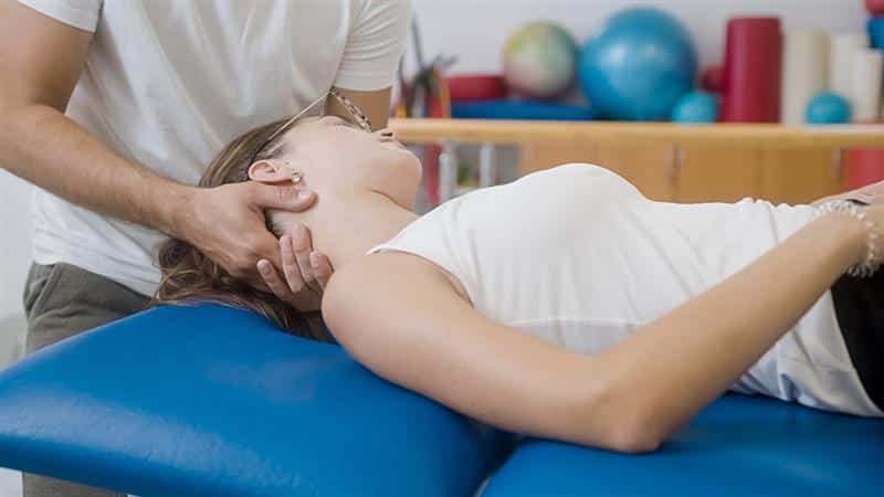 Woman laying on table receiving physical therapy treatment