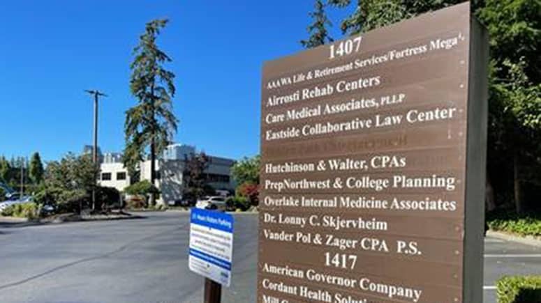 A large directory sign in Washington Business Park showing Airrosti Bellevue among the listed businesses in the park