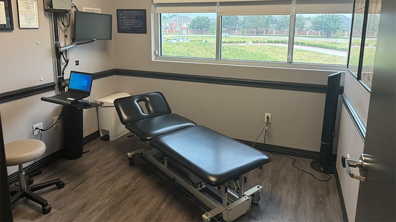 an interior photo of the treatment room at South Grand Prairie. Treatment table is visible.