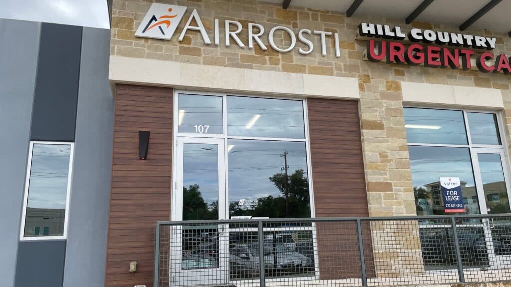 A close up view of the front entrance to Airrosti Stone Oak in San Antonio, TX