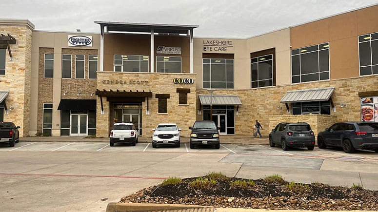 photo of the building exterior of Airrosti Towne Lake. Airrosti logo visible on the 2nd floor of the building