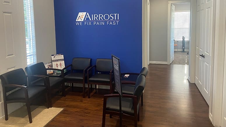 a photo of the lobby at Airrosti Spring-Klein. Airrosti logo is visible on the back wall