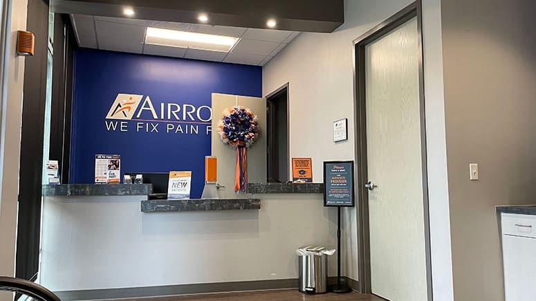 An interior view of the front desk in the lobby at Airrosti Med Center in San Antonio, TX