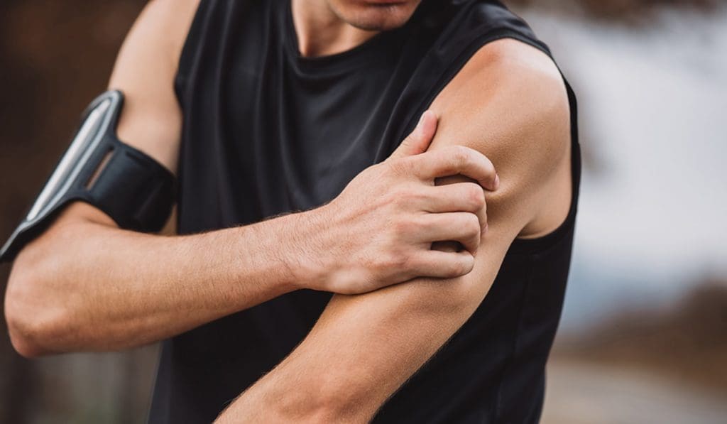 Man grabbing his bicep in pain