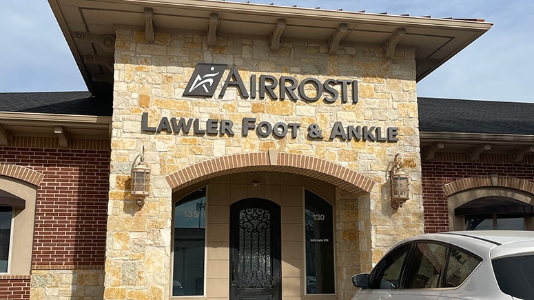 exterior photo of the Airrosti Carrollton building entrance. Includes a visual of the Airrosti signage