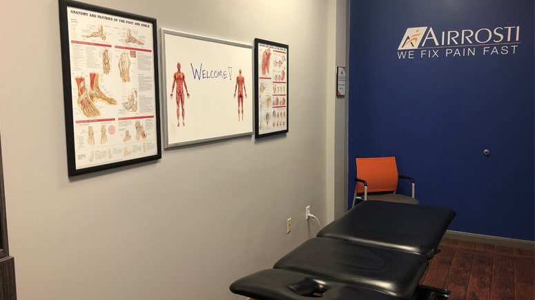 The treatment room at Airrosti Oak Forest where the patient's physical health is assessed and issues are identified and treated.