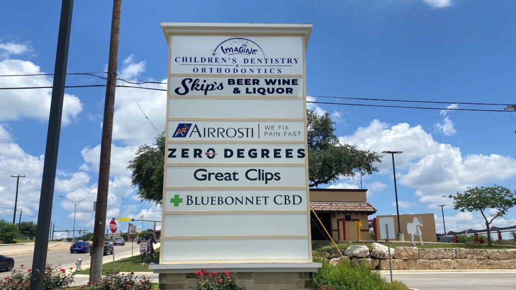 A business suite sign can be seen from the road with Airrosti listed as one of the businesses in the area.