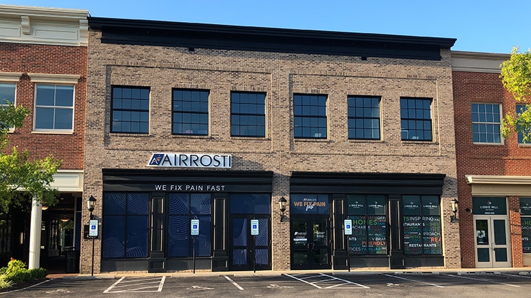 The building exterior of Airrosti Libbie Mill in Richmond, Virginia near the intersection of Roux Street and Libbie Mill Blvd East.