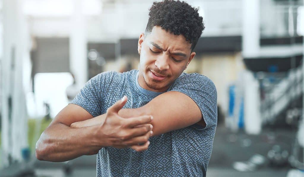 man holding his elbow in pain