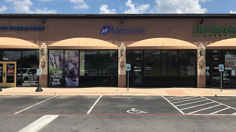 A wide view of the building exterior outside of Airrosti Lakeway in Lakeway, TX, just northwest of Austin, TX.