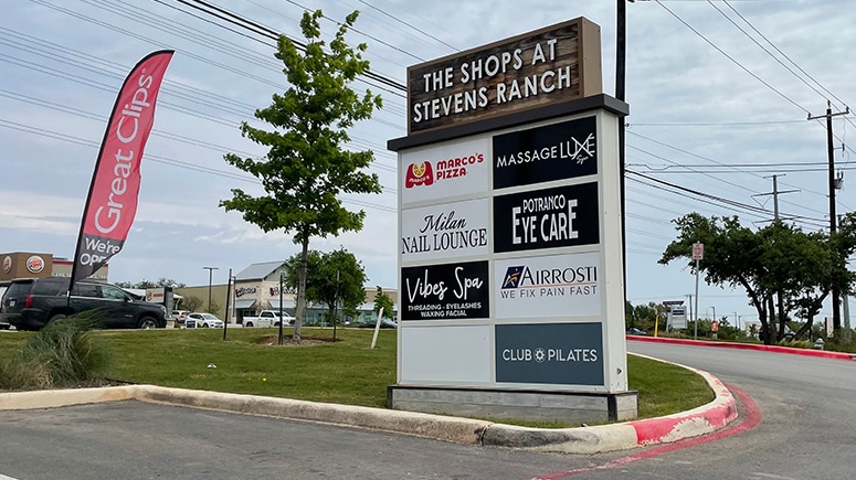 A photo of a large directory sign which can be seen from the road listing the businesses of The Shops at Stevens Ranch, where Airrosti Stevens Ranch is located.
