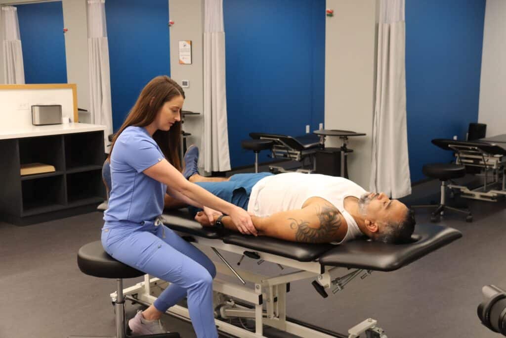 Man receiving manual therapy treatment from a healthcare provider