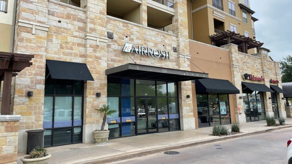 An exterior view of the Airrosti Quarry Village building in San Antonio, TX