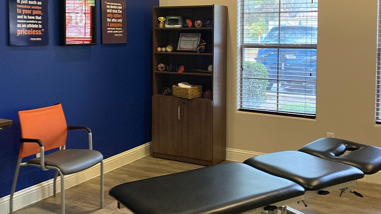 A look inside the treatment room at Airrosti Southlake. A treatment table is visible in the center of the room.