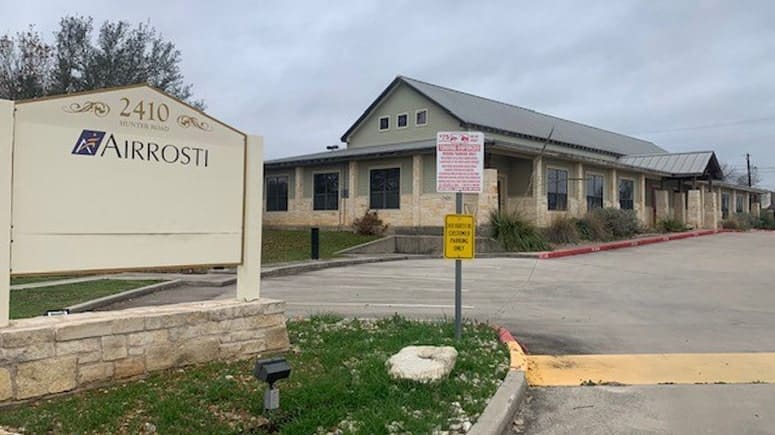 The building exterior of Airrosti San Marcos, located at 2410 Hunter Rd in San Marcos, Texas.