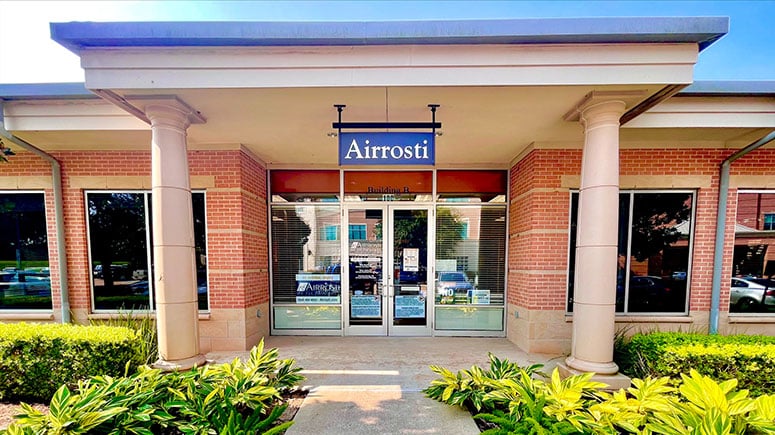 Photo of the exterior building of Airrosti Sugar Land. The airrosti sign is located about the front doors.