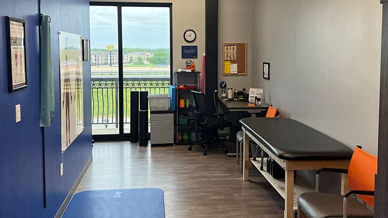 A photo of inside the recovery room at Airrosti Burleson. Exercise mat and foam rollers are visible.