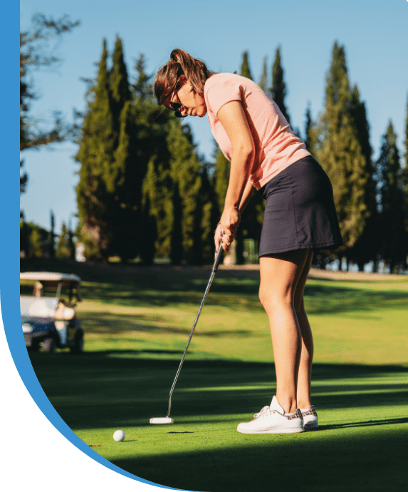 Woman putting golf ball on course