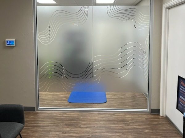 The interion glass wall feature at Airrosti Sherman