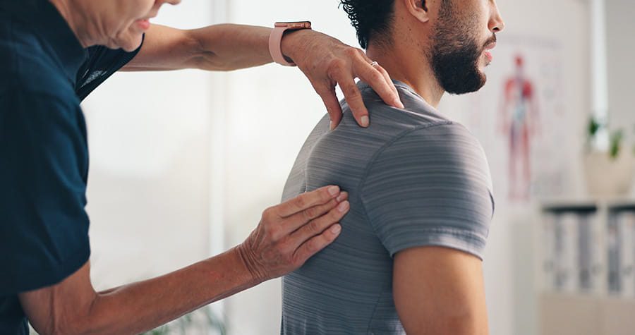 man being examined by a Provider for shoulder pain
