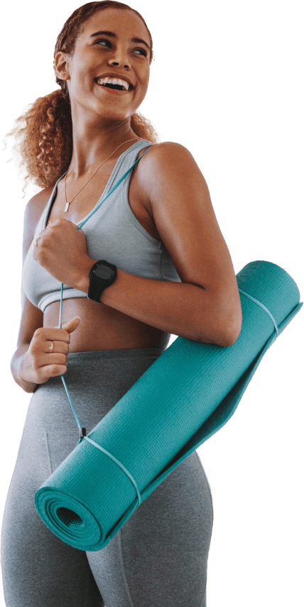 Woman with yoga mat just finishing up in a class