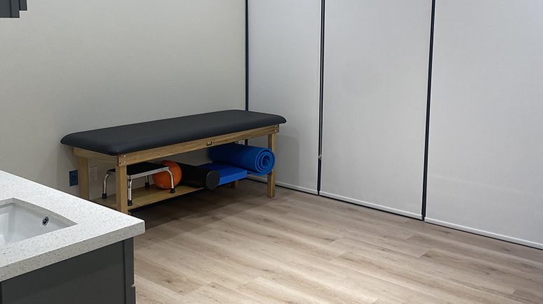 The recovery room inside Airrosti Weslaco, feature a rehab table and various exercise equipment for stretches and active care rehab.