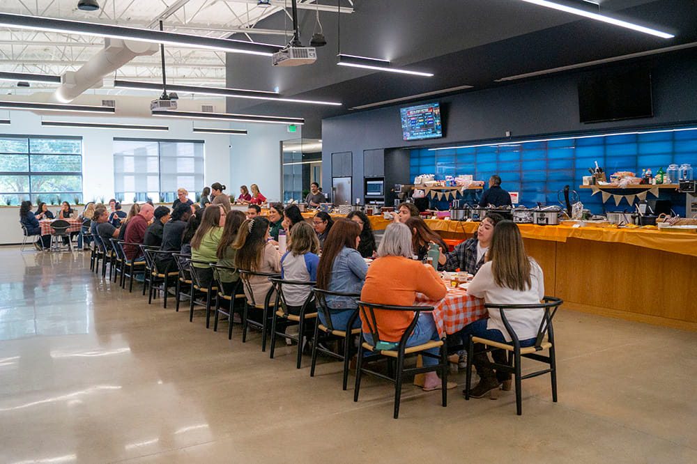 Airrosti employees celebrating Thanksgiving at the annual potluck