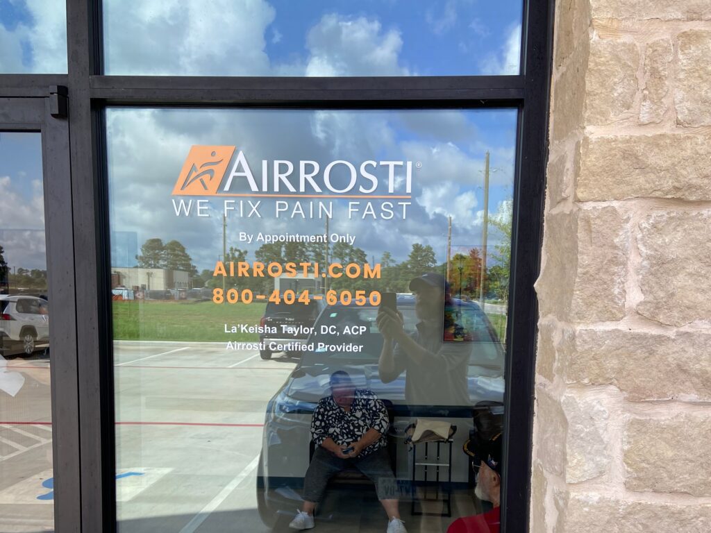 Exterior window and Airrosti logo at Airrosti Magnolia-Aubudon